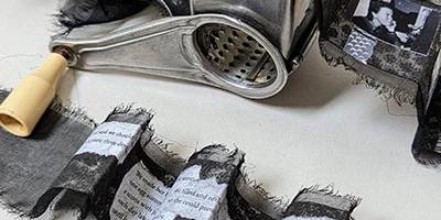 Unique artist book with three sections (two accordions and one scrolled accordion) housed in and attached to a small rotary cheese grater